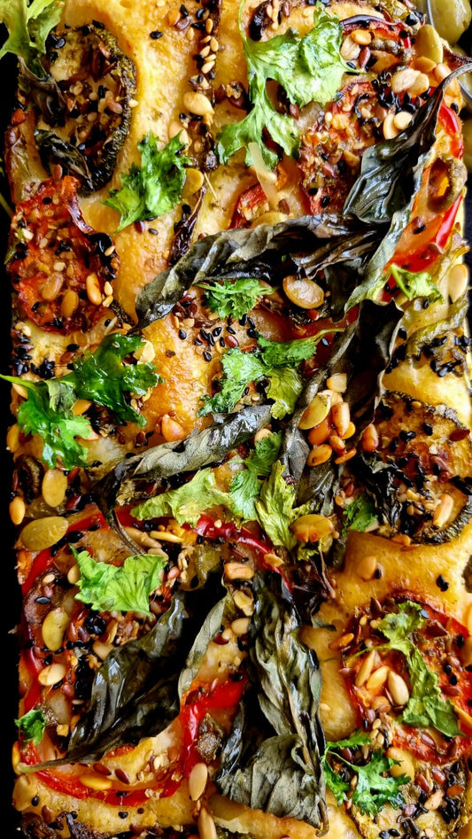 focaccia breads loaded with vegetables and seeds